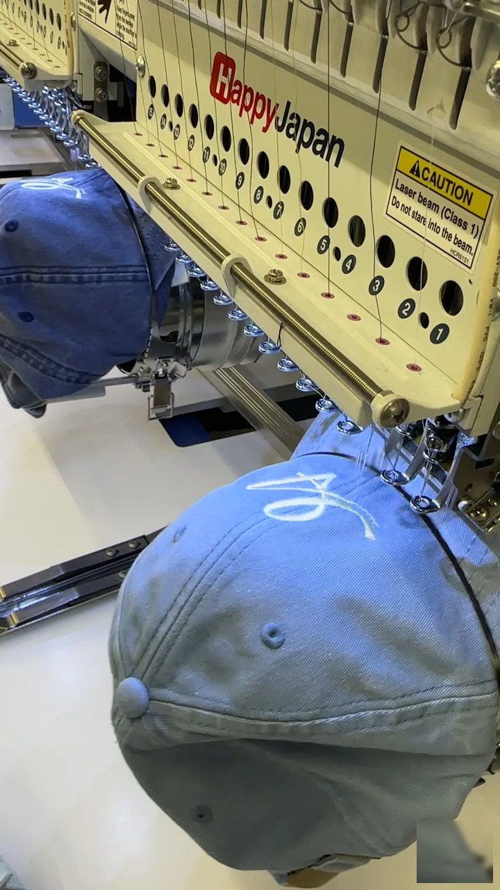 Cap embroidery in progress on HappyJapan machine