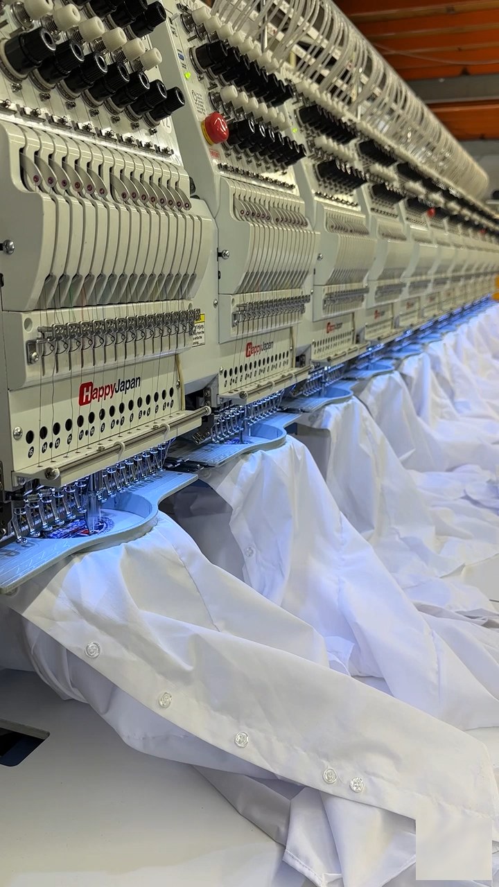 Shirts loaded across the embroidery machine heads
