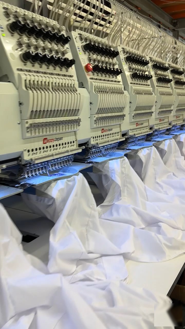 Close-up of embroidery machine heads during production